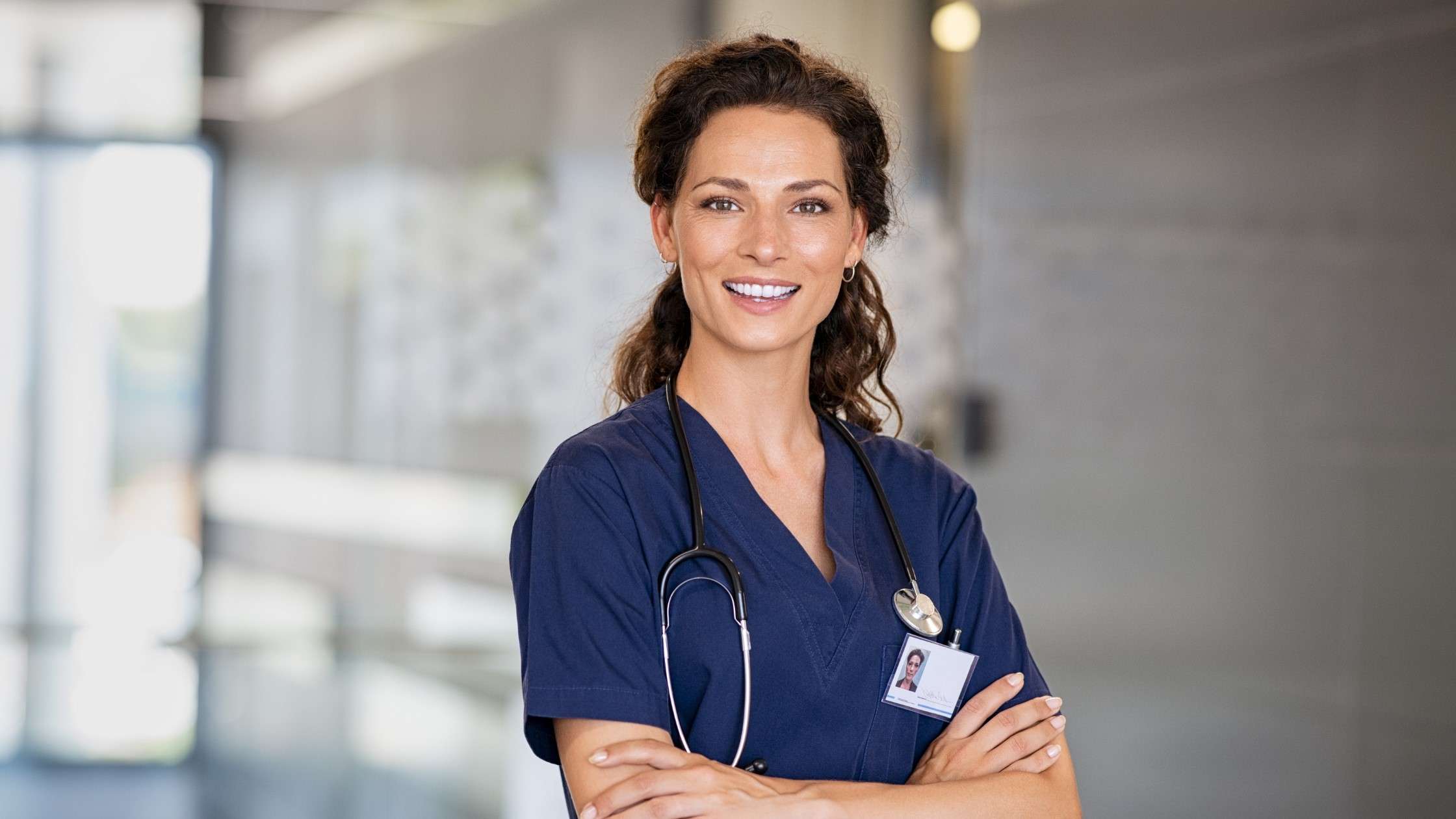 Headshot of a smiling Advanced Practice Provider wearing scrubs.